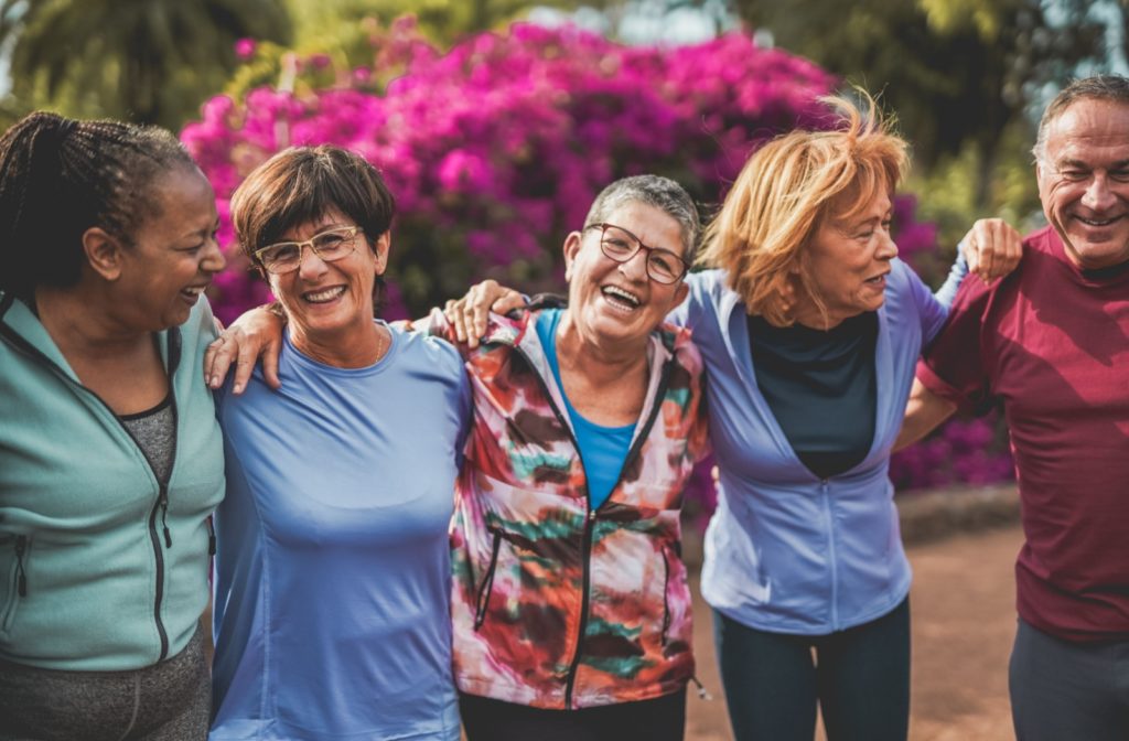 A group of seniors link arms, sharing laughter together.